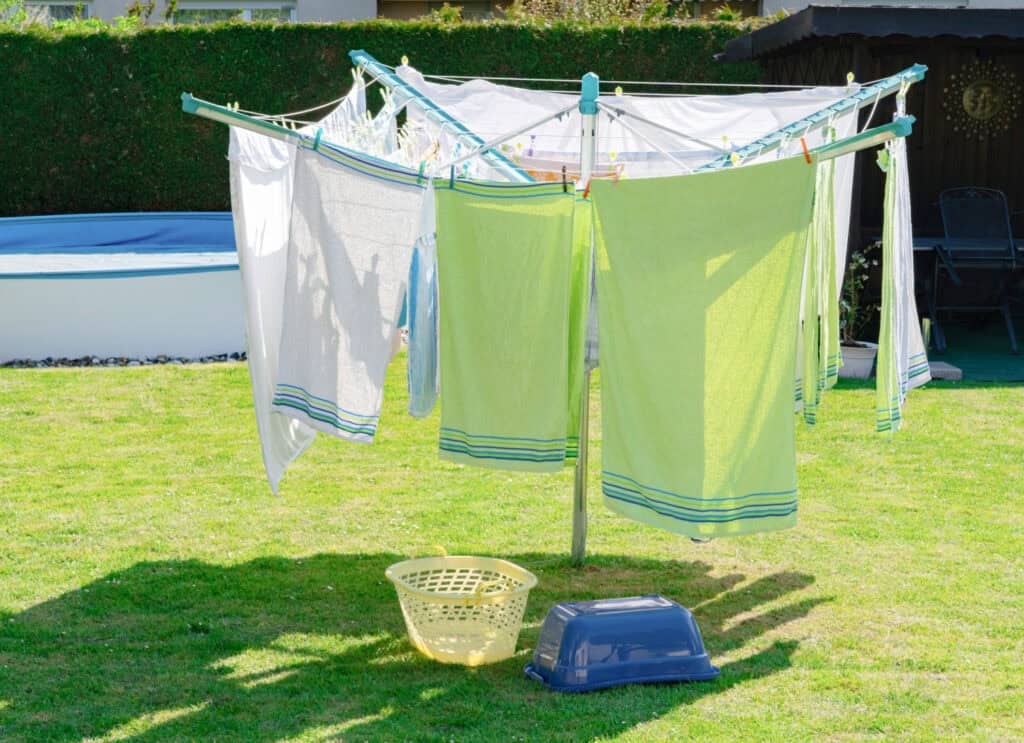 clothes hanging on a rotary line setup outside