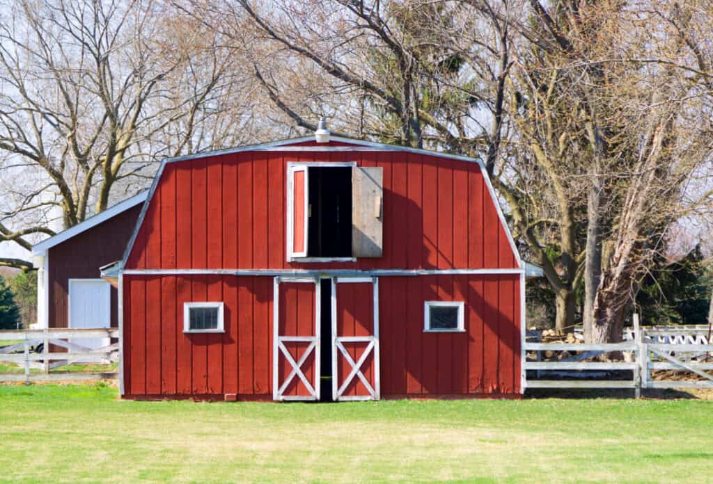 red barn on a spring day in may with the doors slightly open