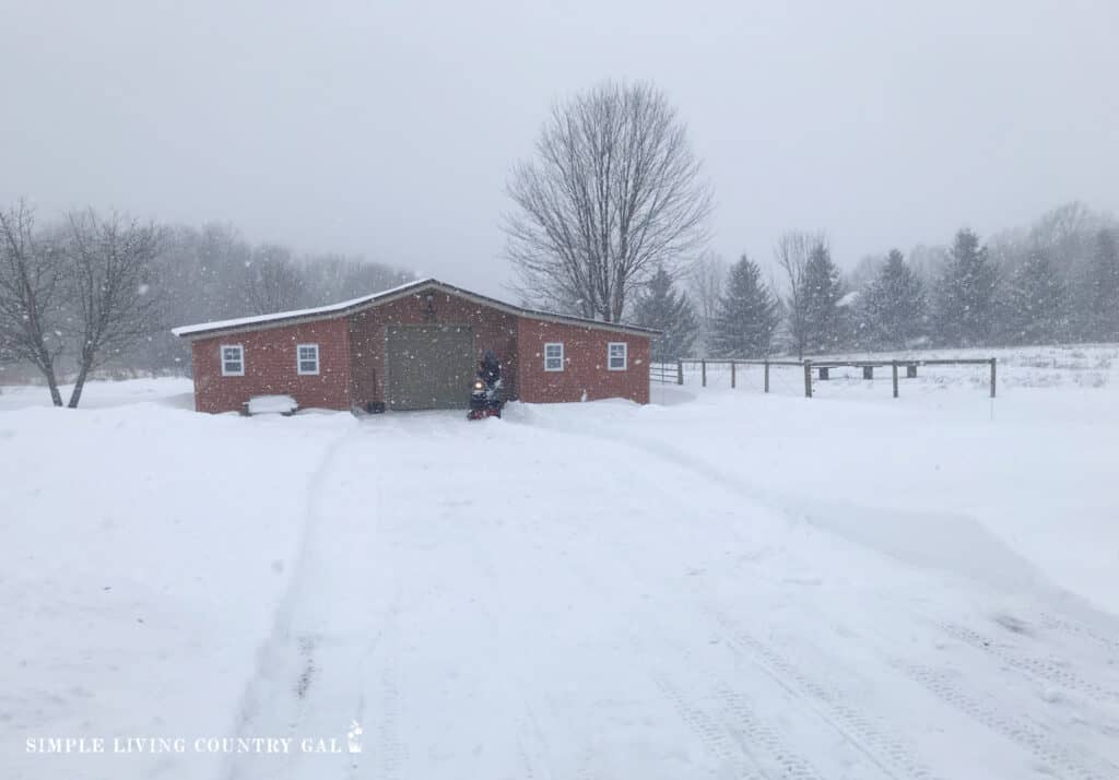 winter barn in December, heavy snow falling